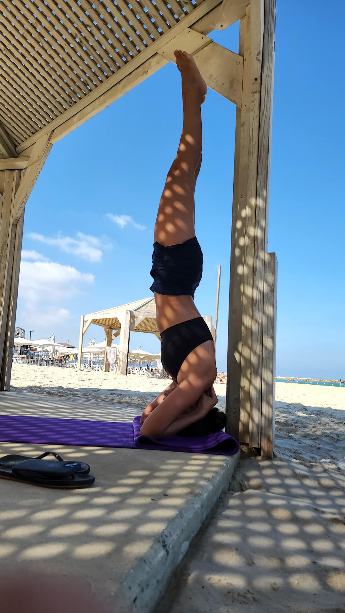 Yoga handstand on the beach